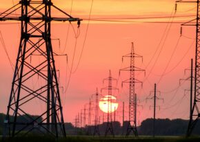 silhouette of electric post during sunset